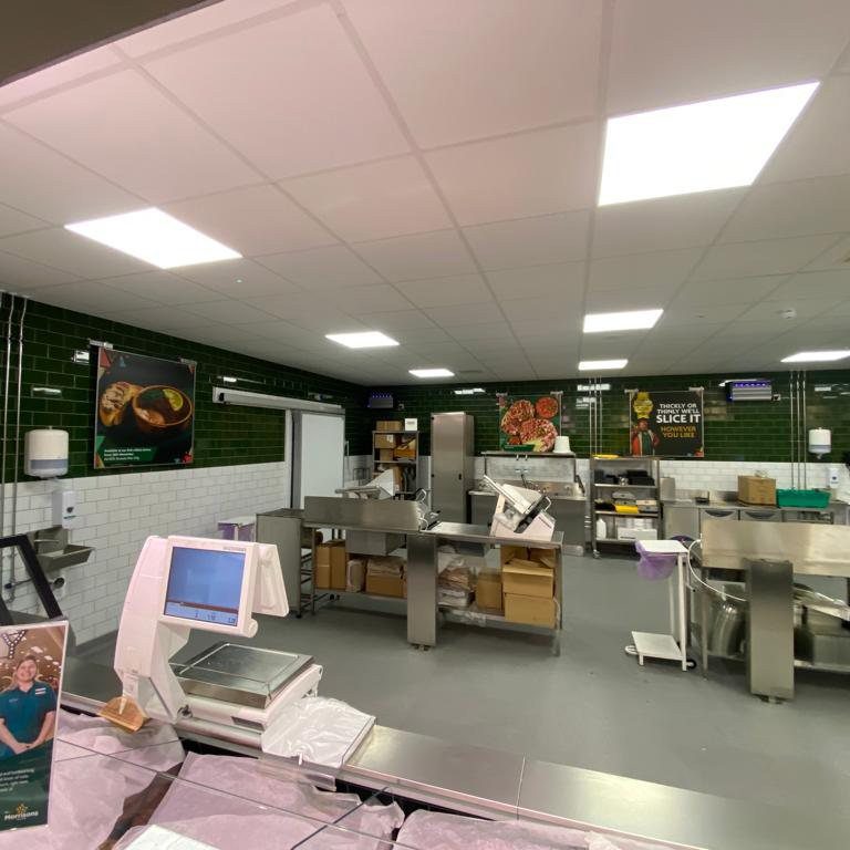 Supermarket kitchen with green and white tiled walls