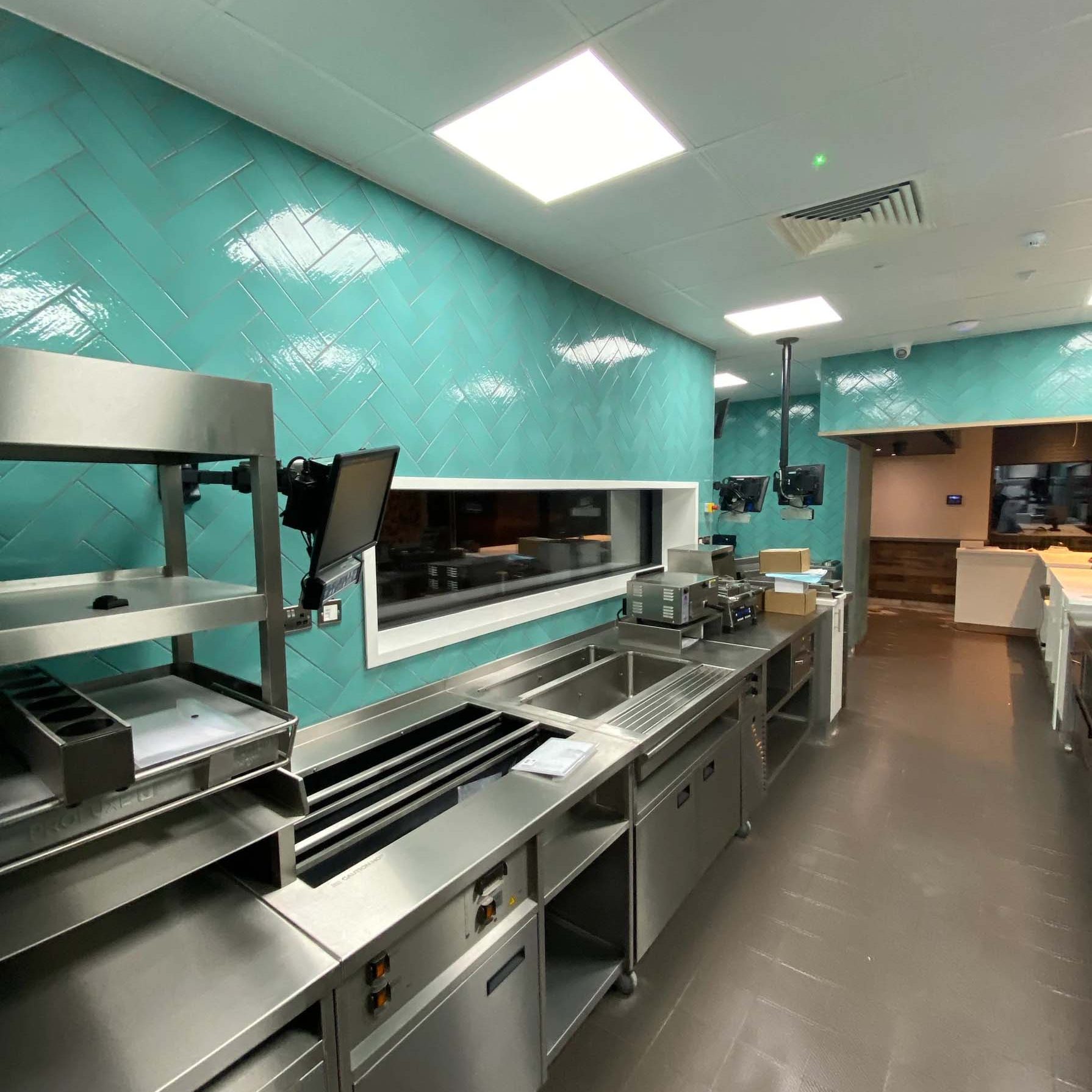 Commercial Kitchen with blue herring bone tiles walls